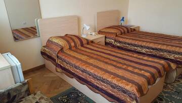 Кровать в двухместном номере с 2 отдельными кроватями в Санатории Санаторий Янтарный Берег